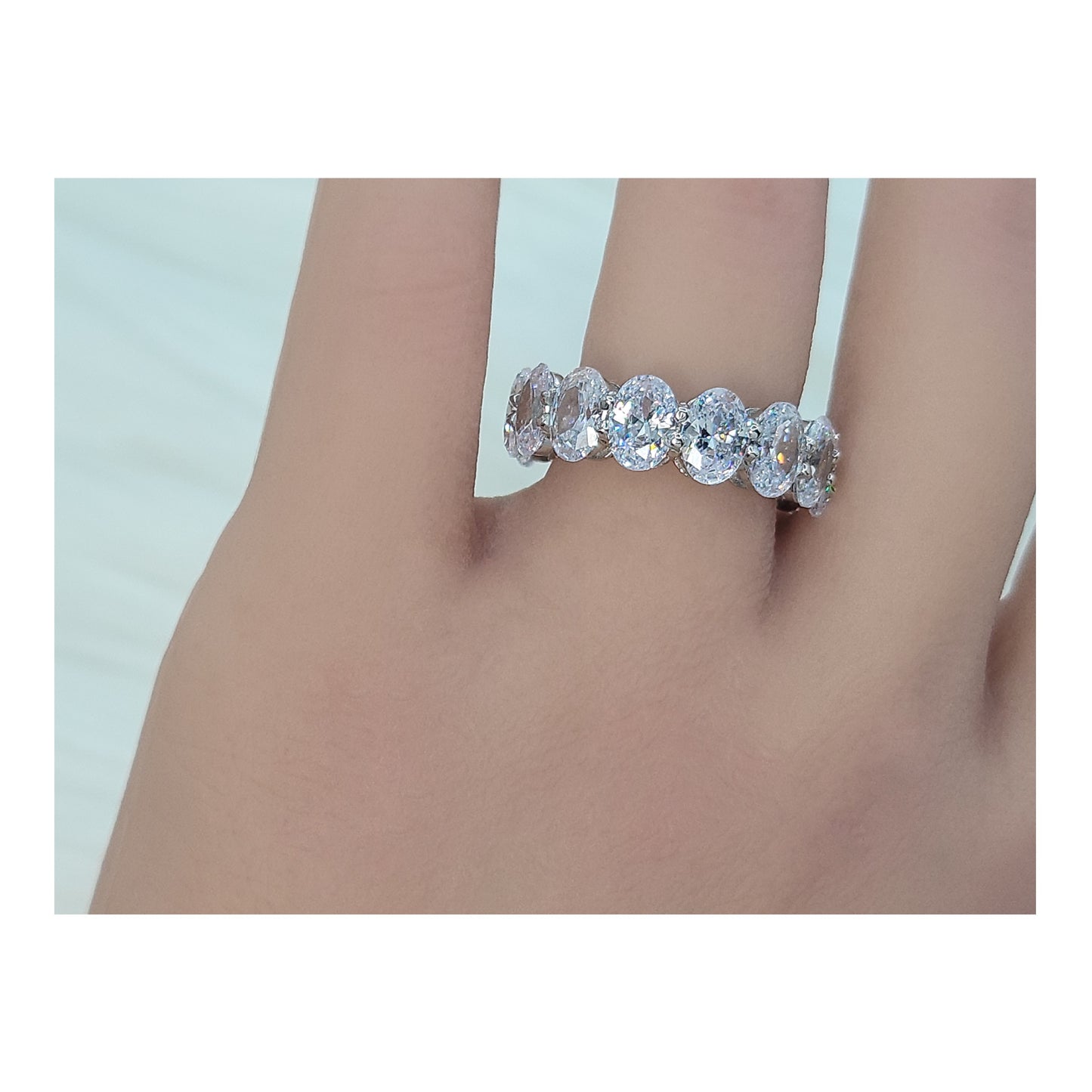 DANAMARIE White CZ Diamond Simulant Oval Cut Eternity Ring in Rhodium Over Sterling Silver